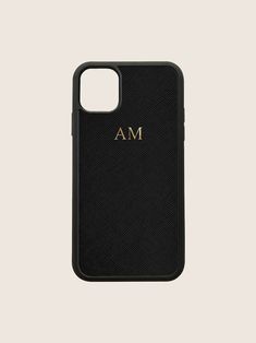 a black iphone case with the letter m on it, and gold lettering in front