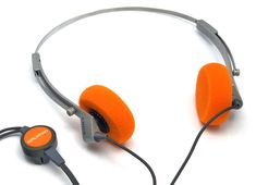 an orange headphone with ear buds attached to it