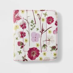 a white wallet with pink flowers and green leaves on the front, sitting against a white background