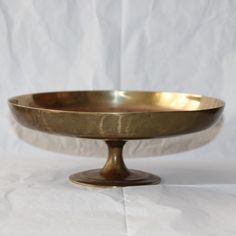 a large metal bowl sitting on top of a table