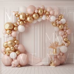 a large balloon arch with gold, white and pink balloons