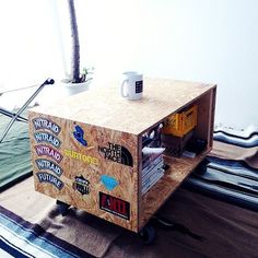 a coffee table made out of plywood with stickers on the top and bottom