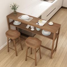 a kitchen table with three stools next to it