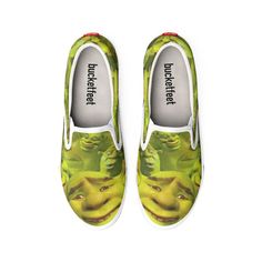 a pair of shoes with the face of an alien on them, printed in green and yellow