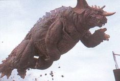 an image of a godzilla flying in the air