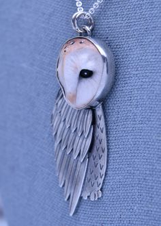 We all know owls as symbols of knowledge and wisdom, and in tattoo culture, they can also represent hope. The polymer clay owl face was handmade by a Ukrainian clay artist and sits in a handmade sterling silver bezel atop hand-cut and sculpted sterling silver feathers. Chain Sold Separately Material: Sterling SilverStone Type: Polymer ClayStone Size: 21.5mm x 20.2mmDimensions: 62mm x 24mmChain Type: Sold separately; add to cart below. Shown with 1.7mm Cable ChainFinish: Antiqued, tumbledWeight: Polymer Clay Owl, Owl Face, Silversmith Jewelry, Clay Owl, Tattoo Culture, Clay Moulding, Clay Artist, Silversmith Jewellery, Polymer Clay Mold