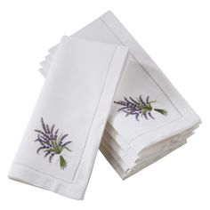 four white napkins with lavender embroidered on them