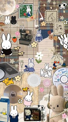 the wall has many stickers on it and there is a stuffed animal next to an old record player