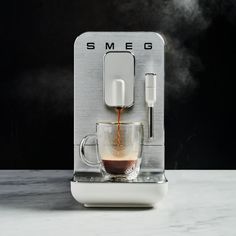 an espresso machine with coffee being poured into it