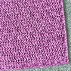 a crocheted pink cloth is laying on the floor