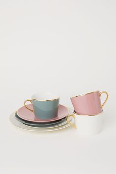 two cups and saucers sitting on top of each other