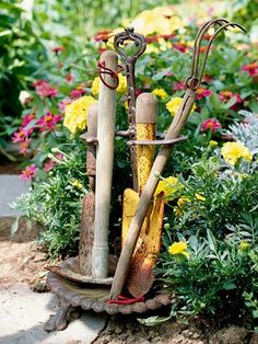 an assortment of garden tools sitting in the middle of flowers