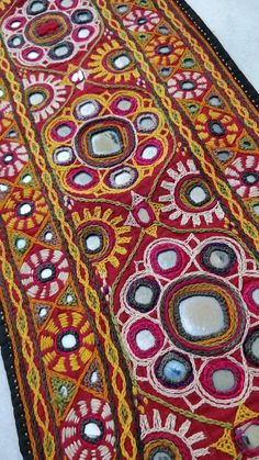 a red and yellow area rug with circles on it