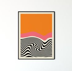 an orange, pink and black art piece hanging on a wall
