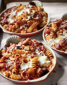 three bowls filled with different types of pasta