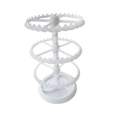 a white plastic object with gears on it's sides and an upside down stand