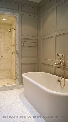 a large white bath tub sitting next to a walk in shower