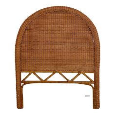 a brown wicker headboard with an arched top