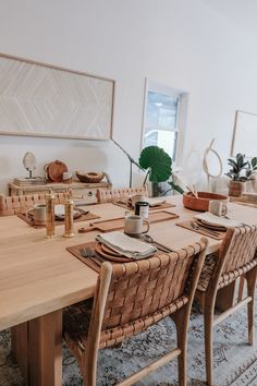 a dining room table set with place settings