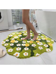 a person standing on a rug in the middle of a bathroom