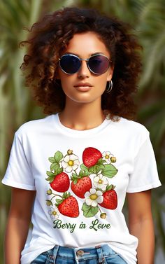 a woman wearing sunglasses and a t - shirt with strawberries on it, says berry in love