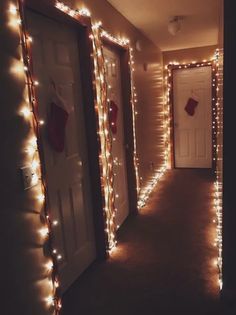 the hallway is decorated with christmas lights and stockings