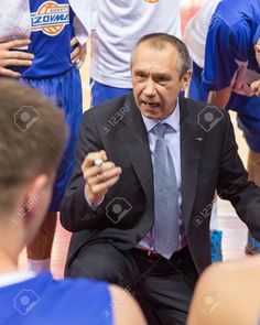 a coach talking to his team during a basketball game stock photo - 957982