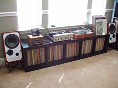 an entertainment center with record players and speakers