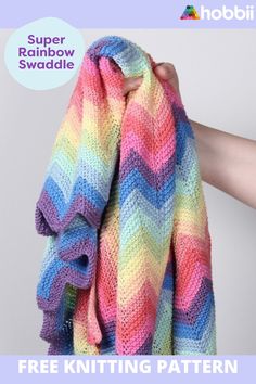 a hand holding a colorful knitted scarf with the text super rainbow swaddle free knitting pattern
