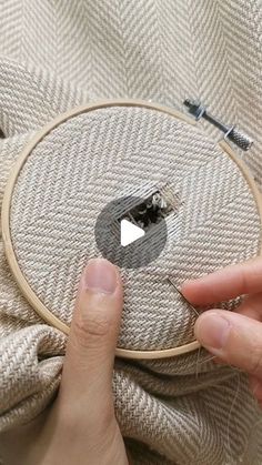 someone is stitching something in the middle of a piece of fabric