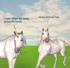 two white unicorns with long horns standing next to each other on a green field