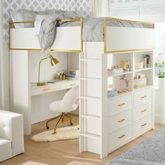 a white loft bed with gold trim and drawers underneath it, next to a desk