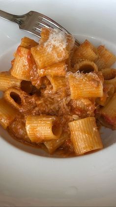 a white bowl filled with pasta and sauce