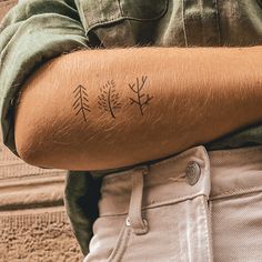 a man's arm with a flower tattoo on the left side of his arm