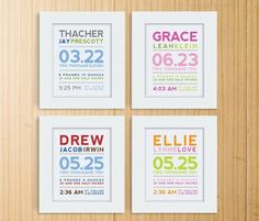 four framed baby's birth announcements are displayed on a wooden surface with the names and numbers