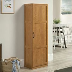 a tall wooden cabinet sitting in the corner of a room