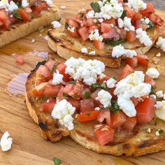 some toasted bread topped with tomatoes and feta cheese