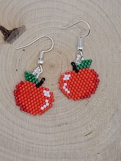 a pair of red and green beaded fruit earrings