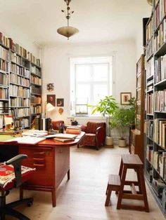 a home office with lots of books on the shelves