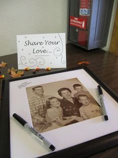 an old photo is displayed on a table with a note and pen in front of it that says share your love