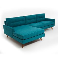 a blue couch and ottoman on a white background