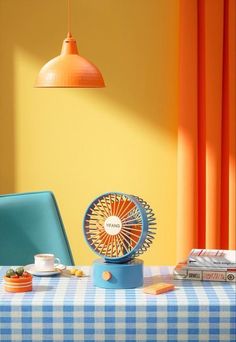 a table with a blue and white checkered table cloth, an orange light hanging from the ceiling