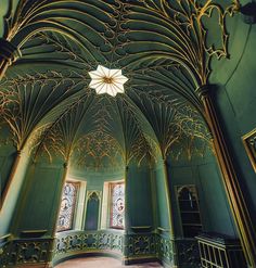 an ornately decorated room with green walls and wood floors