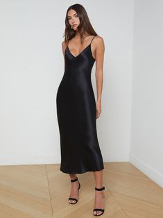 Our prettiest slip dress is here, offered in pure silk charmeuse. The Seridie mid-length dress features a deep V-neck and a subtly-sexy bias cut that clings to the figure before draping straight to a below-calf hem. With no closures for easy, effortless wear, she also includes adjustable straps so you can customize the fit. Pair with a strappy sandal for the perfect special occasion look. | L'AGENCE Seridie Silk Slip Dress In Black Black Slip Midi Dress, Black Satin Slip Dress, Black Strappy Dress, Event Dresses Formal, Black Silk Dress, Black Slip Dress, Midi Slip Dress, Kids Denim, Silk Slip Dress