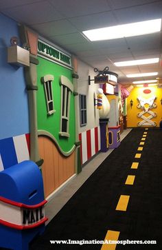 an indoor play area with colorful walls and toys on the floor for children to play in