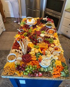 a table covered with lots of different types of food on top of a kitchen counter
