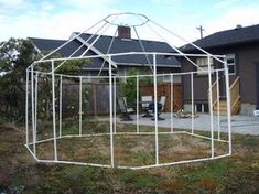 a white structure sitting in the middle of a yard