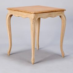 a small wooden table sitting on top of a white floor