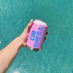 a hand holding a pink can with the words omega on it