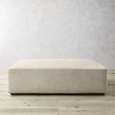 a white couch sitting on top of a hard wood floor